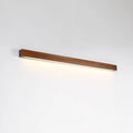 Slim walnut-coloured wooden strip LED wall lamp in three length options on a white wall.