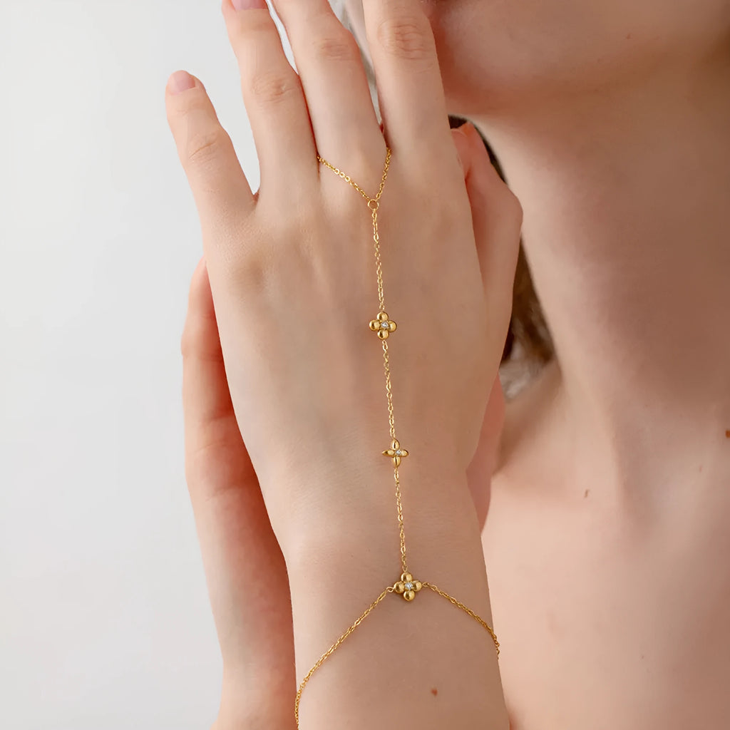 Gold women's stainless steel bracelet with an eight-pointed star and floral geometric design.