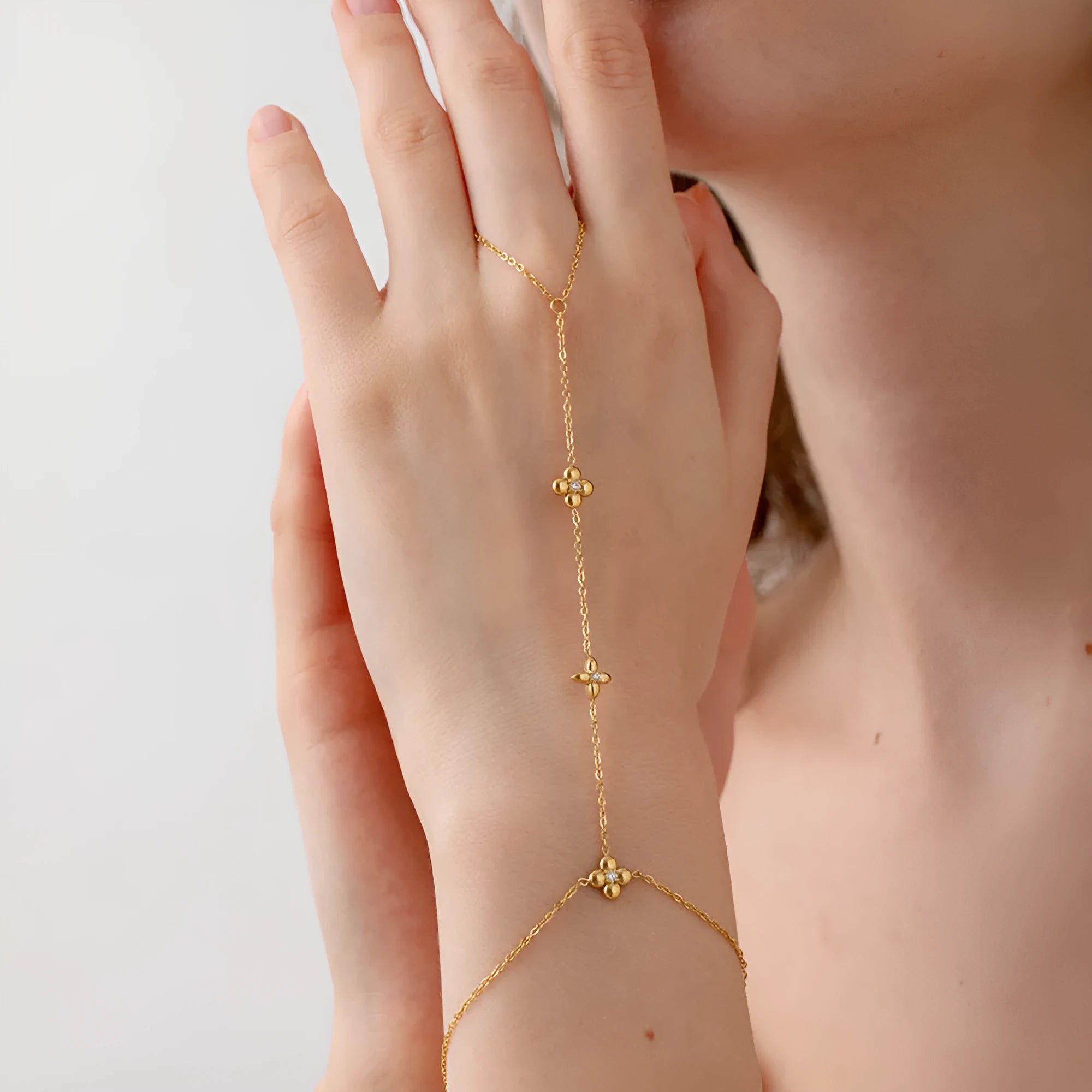 Gold women's stainless steel bracelet with an eight-pointed star and floral geometric design.