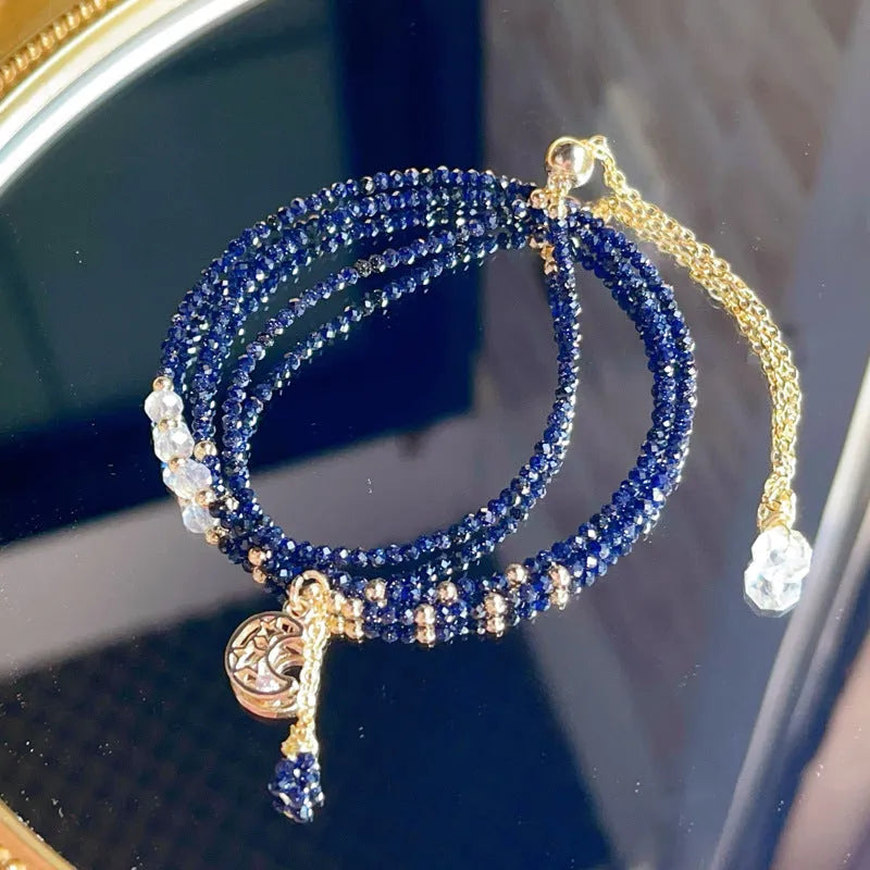 Handmade blue three-ring multi-layer bracelet for women on a wrist.