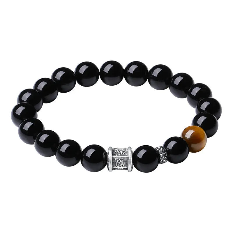 Men's obsidian prayer wheel bracelet with 10mm beads on wrist
