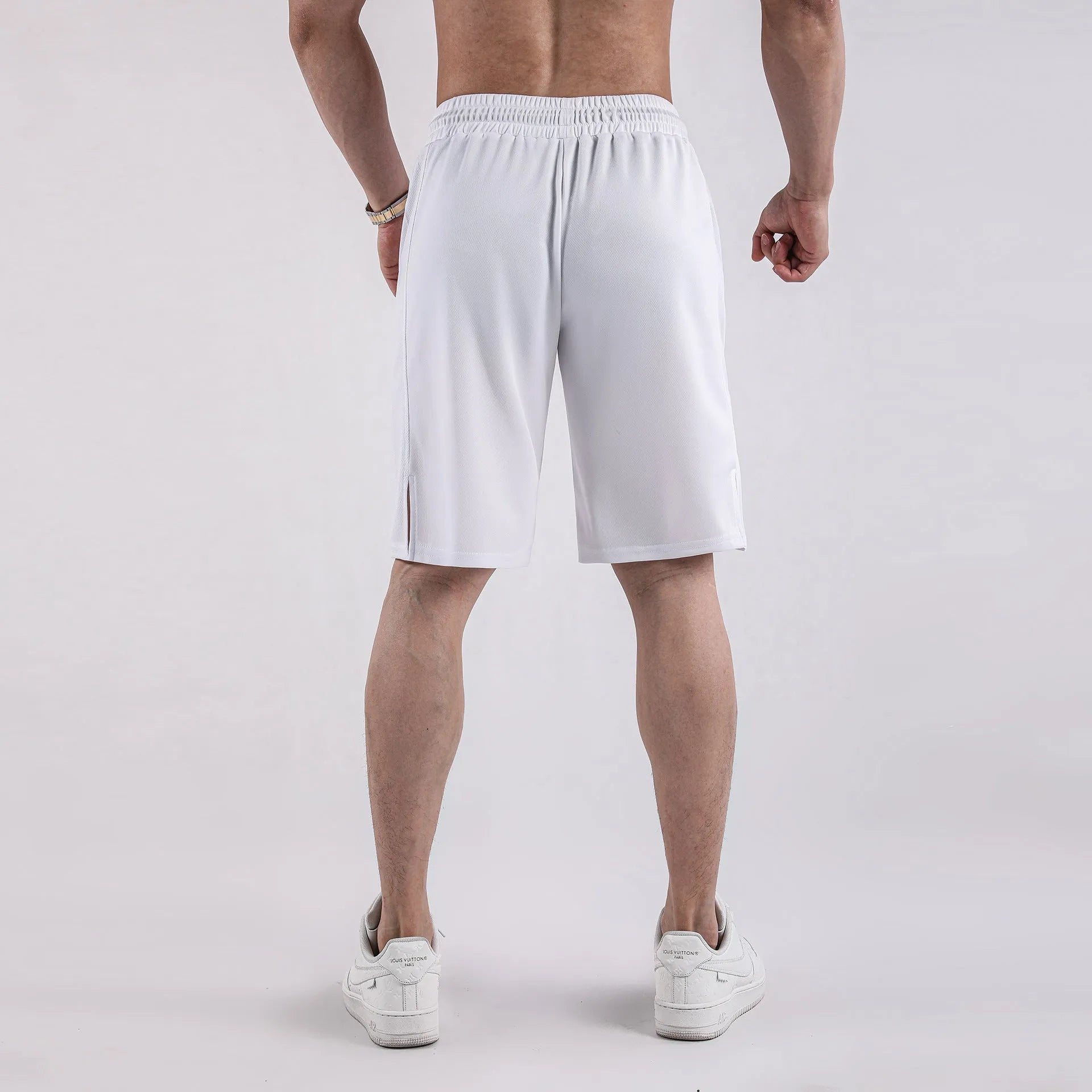 A pair of men's black mesh sports shorts with a loose fit and elasticated waistband.