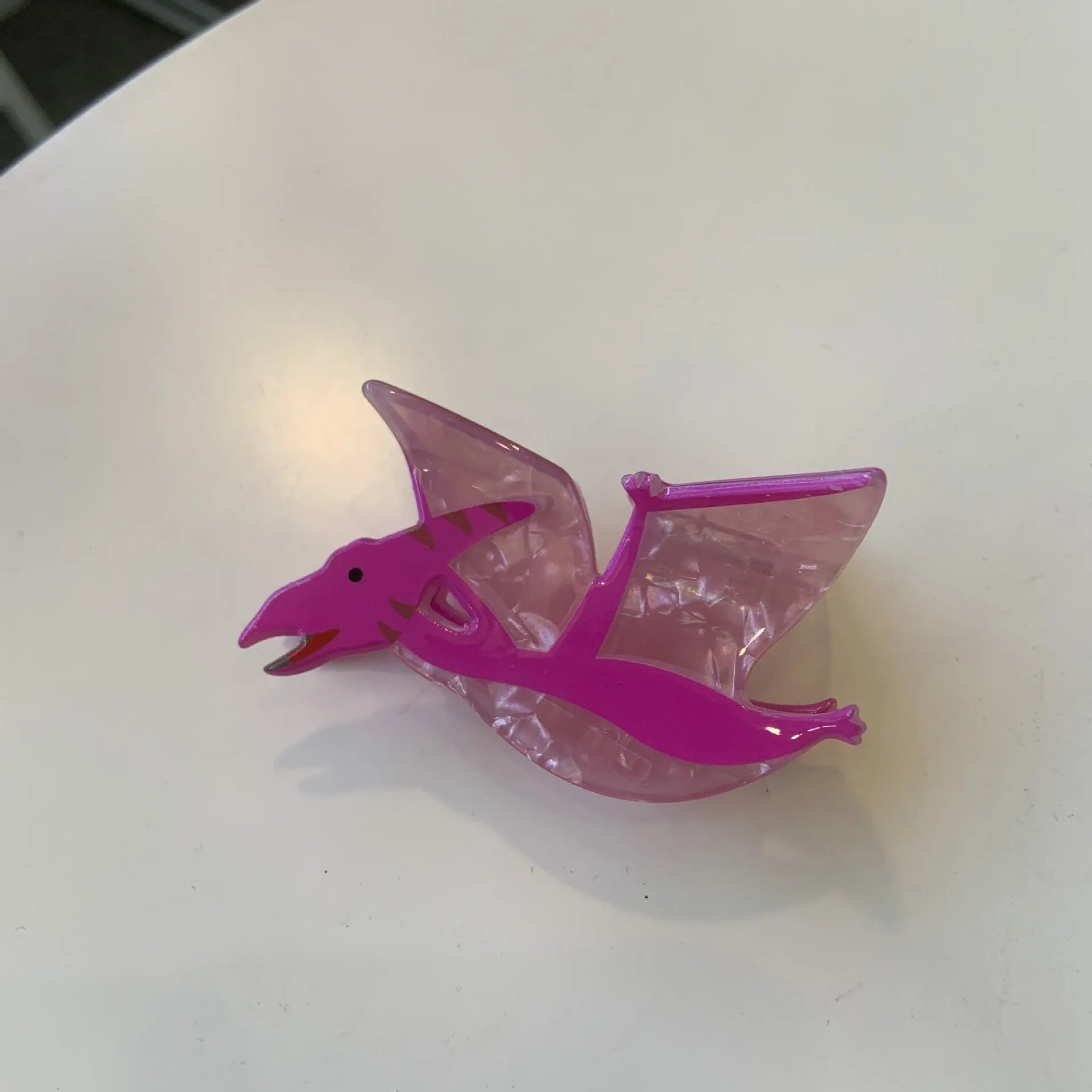 Acrylic dinosaur jaw clip hairpin in blue, brown, green, pink and purple colours with manual grip style