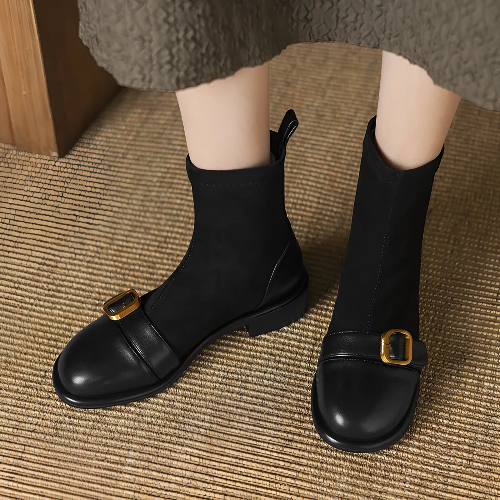 Women's black casual low-heel ankle boots with belt buckle detail and front lace-up closure.
