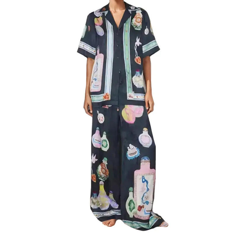 Black women's pyjama set with cartoon print pattern showing matching trousers and top