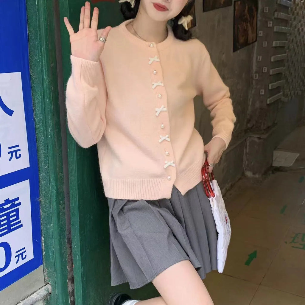 Women's solid colour cardigan sweater with pearl buttons in light blue.
