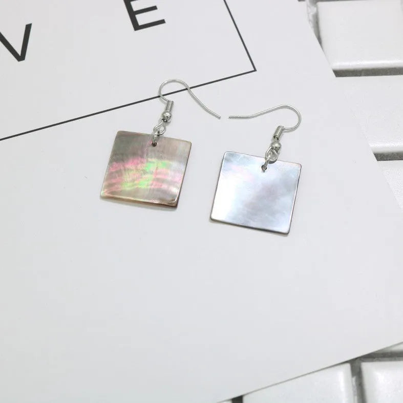Women's geometric shell earrings with rectangular or square panther designs in natural colours
