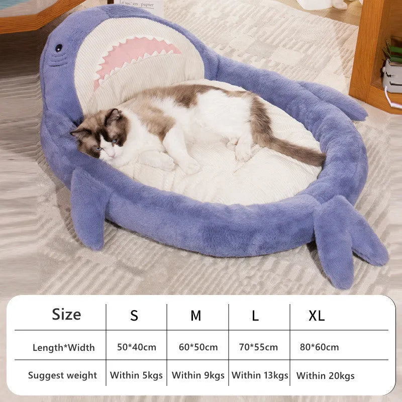 Blue shark pattern pet bed cushion for a small dog on a wooden floor