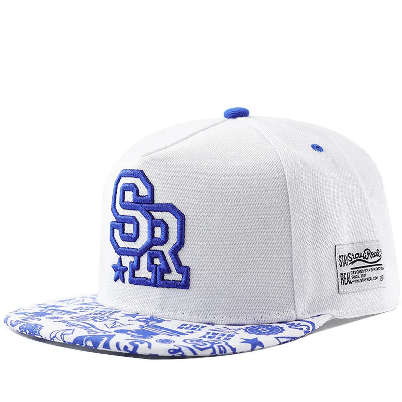 Cotton baseball cap with embroidered letters on the front, shown in black and white colours.