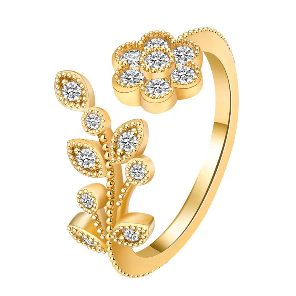 Gold and white women's open ring with floral leaf design and diamond treatment.