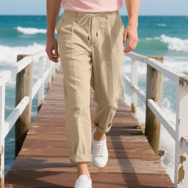 Men's light khaki linen casual trousers with a drawstring waist and straight-leg fit on a hanger.