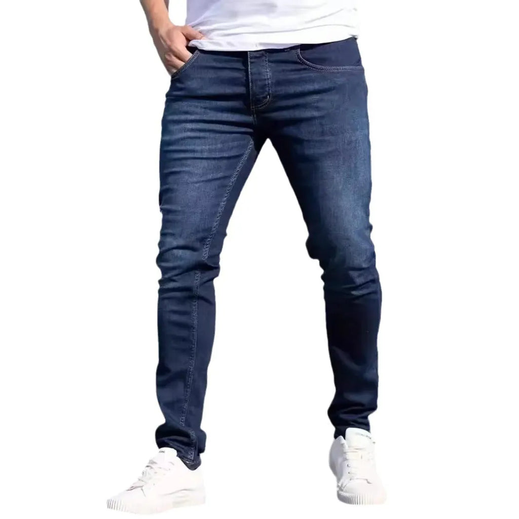 Men's dark blue slim fit casual jeans with a skinny leg and zip fly closure