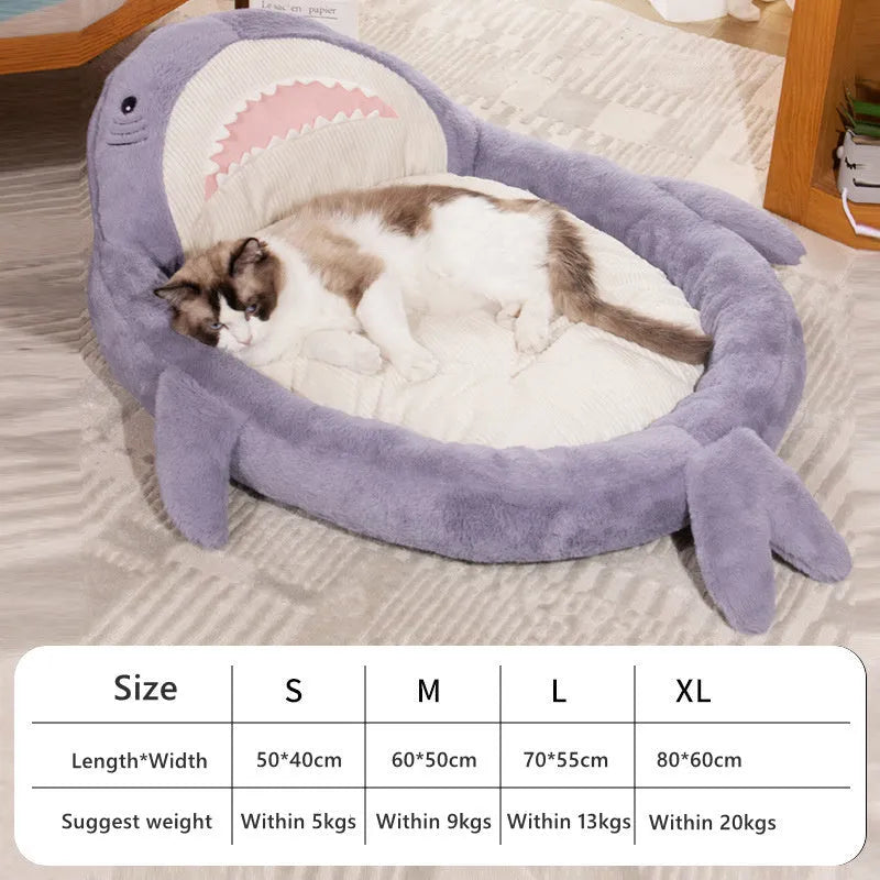 Blue shark pattern pet bed cushion for a small dog on a wooden floor