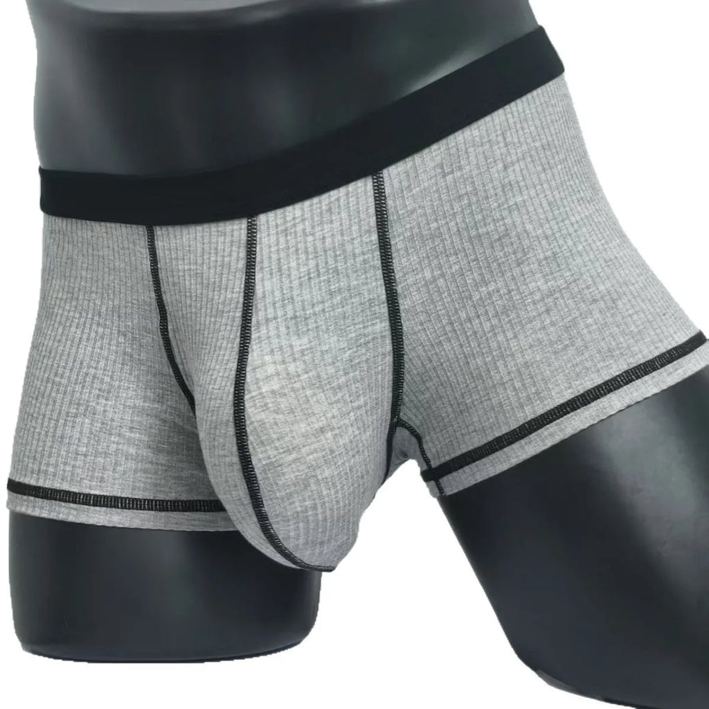 Solid colour men's boxers on a white background, showing thin breathable fabric and body-shaping fit.