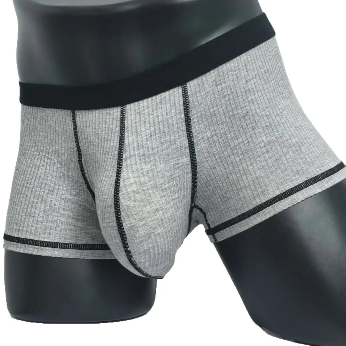 Solid colour men's boxers on a white background, showing thin breathable fabric and body-shaping fit.
