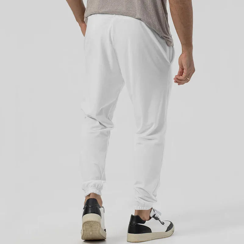 Men's grey track sweatpants with elastic waistband and straight-leg tapered fit