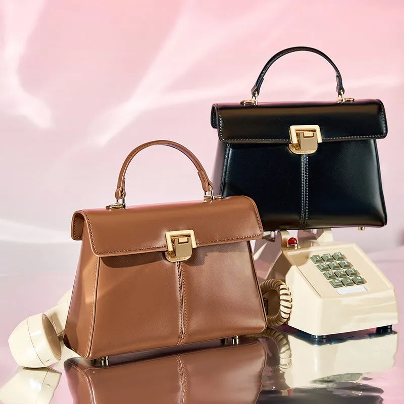 Women's genuine leather shoulder bag with vachette clasp in horizontal square design showing internal compartments