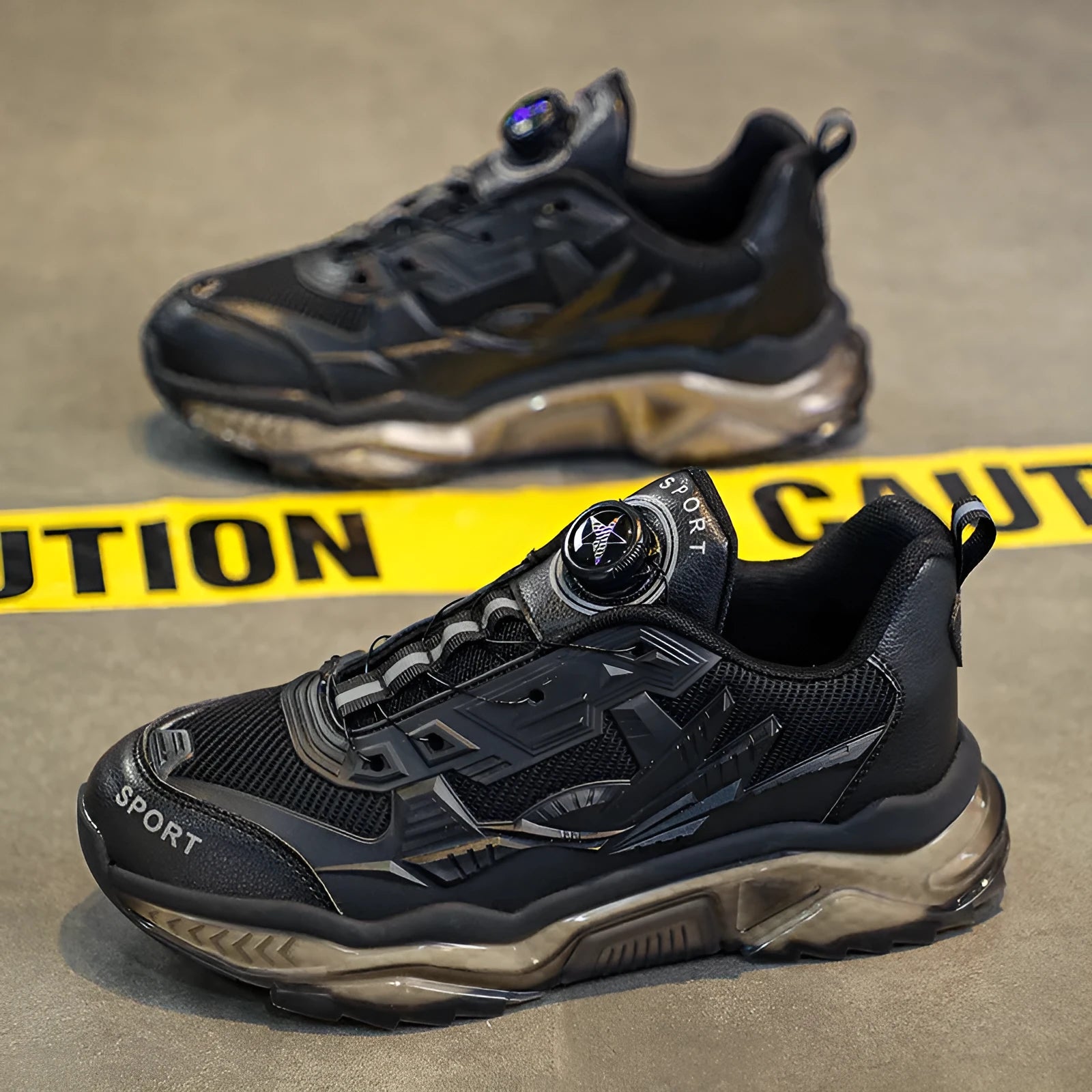 Men's black casual sneakers with a rotating button closure and low-top design.