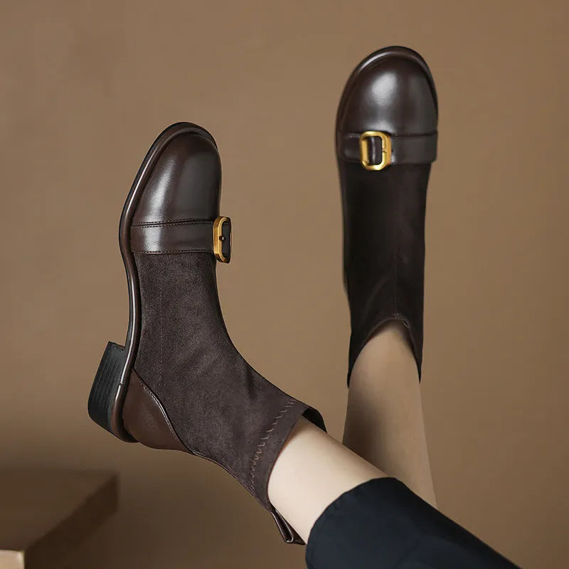 Women's black casual low-heel ankle boots with belt buckle detail and front lace-up closure.