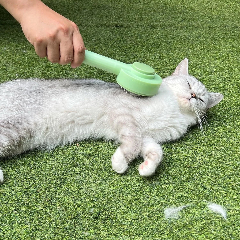Green and yellow pet grooming brush with stainless steel teeth and hanging loop