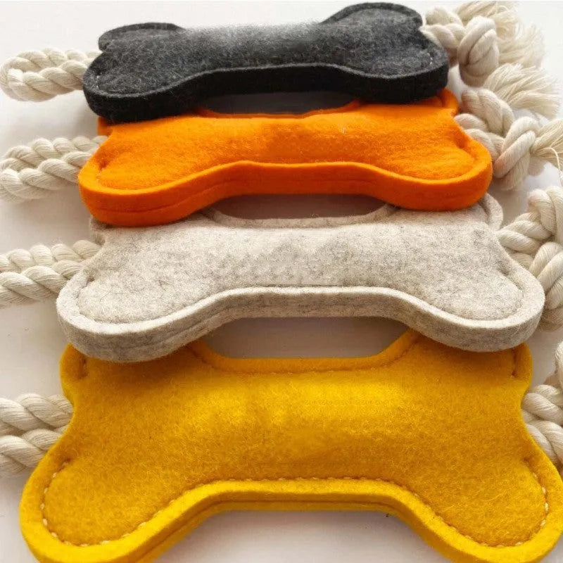Bone-shaped dog chew toy in felt fabric with rope detailing, shown in various colours