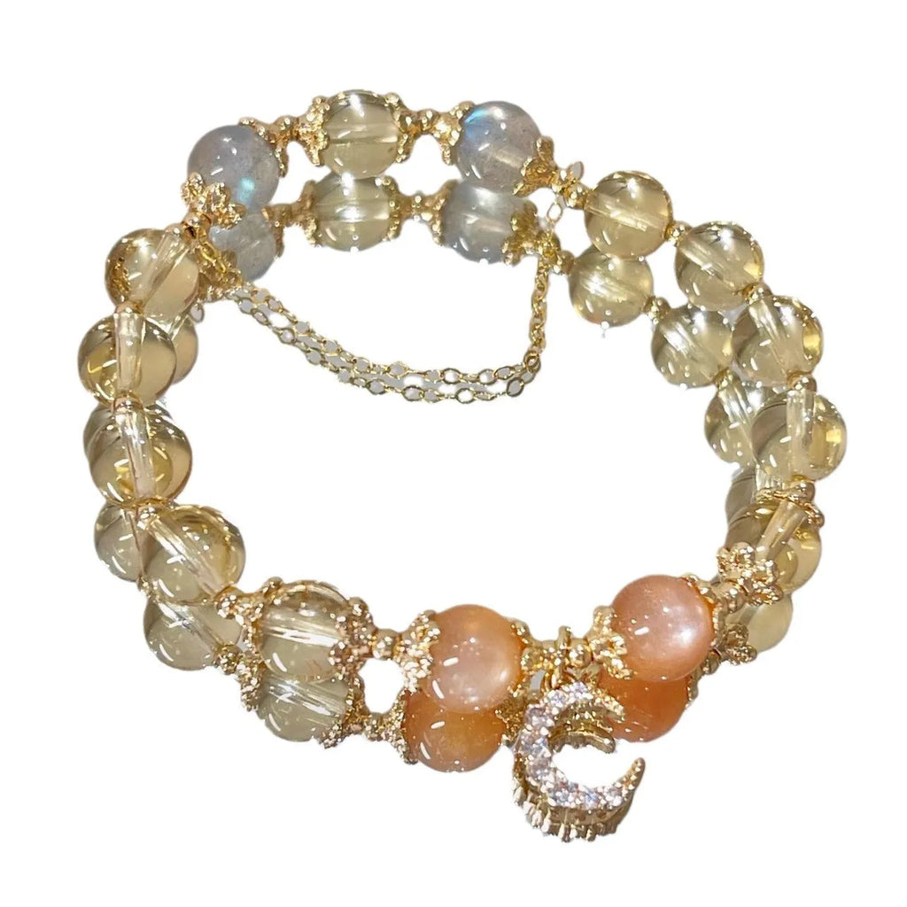 Chinese style crystal bracelet with diamond-shaped stones and gold electroplated finish.