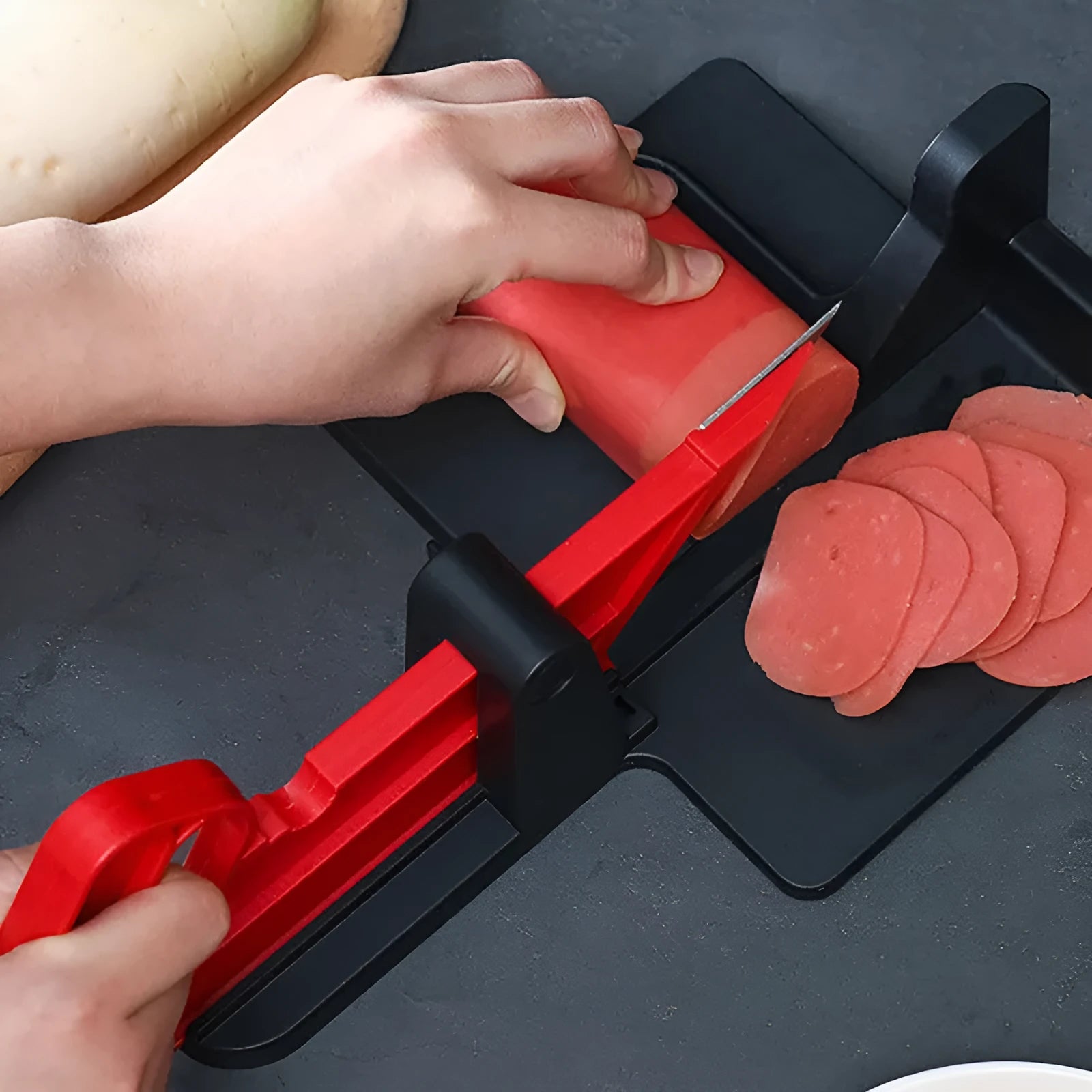 Green and red modern vegetable cutter with stainless steel blades for slicing carrots and potatoes.