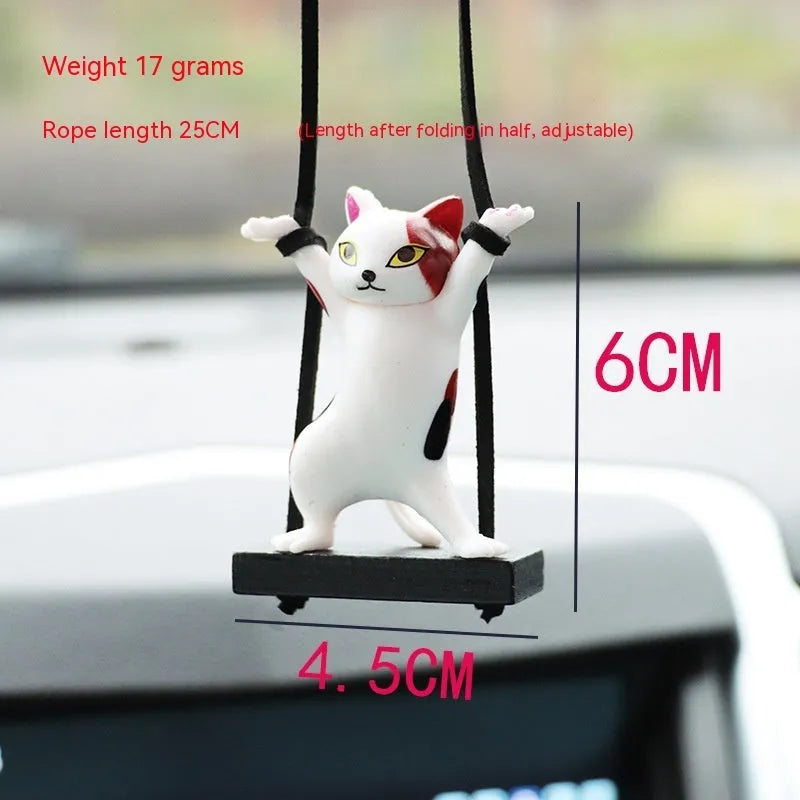 Resin cartoon cat pendant for car interior decoration on adjustable rope.