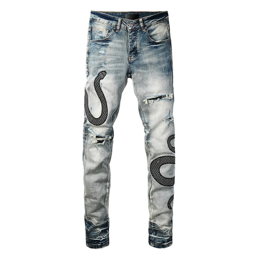 Blue distressed skinny jeans with button fly and tapered leg in street fashion style