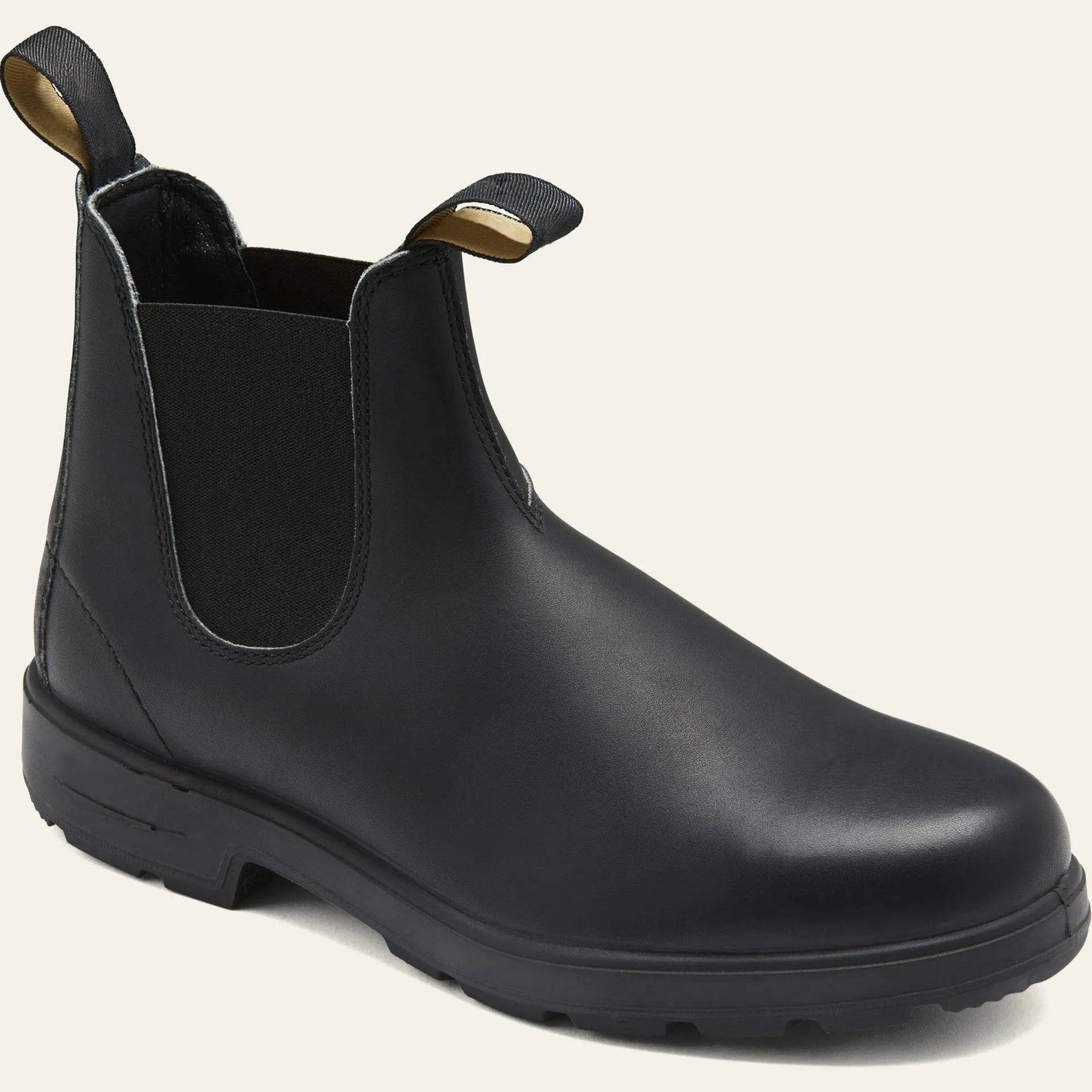 Vintage brown unisex Chelsea boots with a frosted finish, round toe, and low horseshoe heel on a wooden floor.