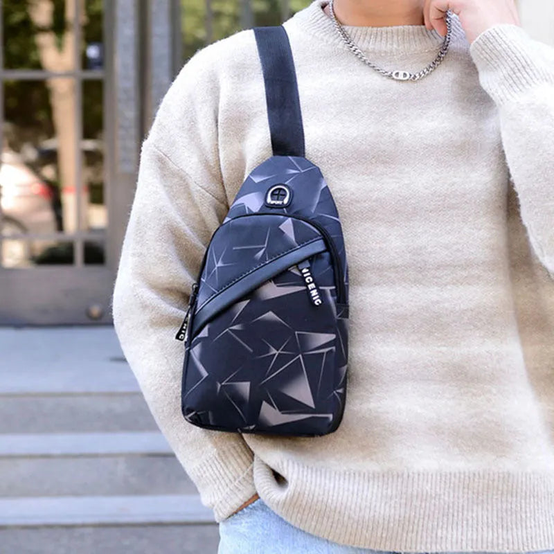 Men's blue Oxford cloth crossbody sling bag with earphone hole design showing zipper opening and letter print detail