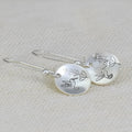 Glossy silver women's earrings with a detailed bird and floral leaf design in a retro style.