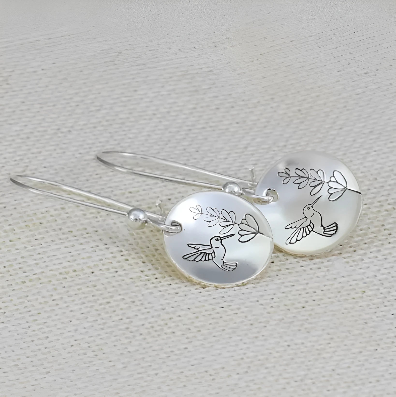 Glossy silver women's earrings with a detailed bird and floral leaf design in a retro style.