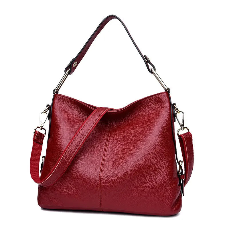 Square vertical genuine leather crossbody bag with multiple internal compartments including phone pocket.