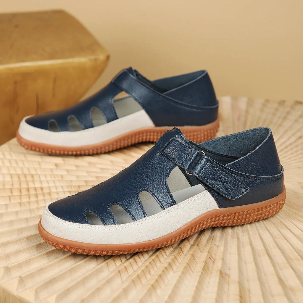 Women's plus size blue flat sandals with a hollow-out toe cap and thick rubber sole.