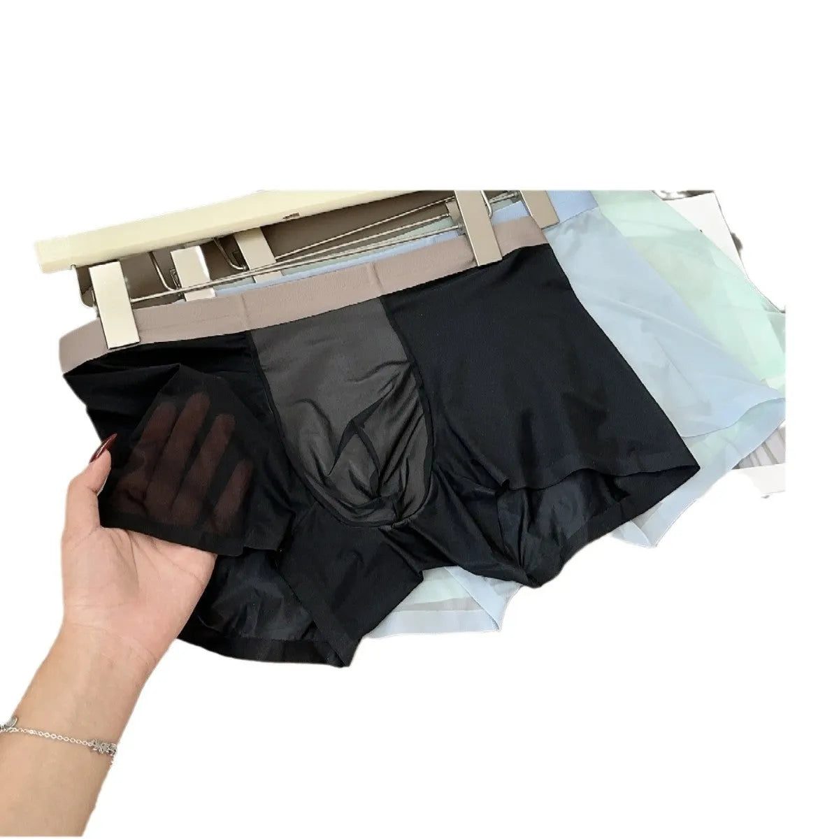 Seamless men's boxer in ice silk fabric showing honeycomb crotch design and mid waist.