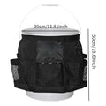Black cylindrical polyester storage bag hanging on a 5-gallon barrel for outdoor tool organisation.