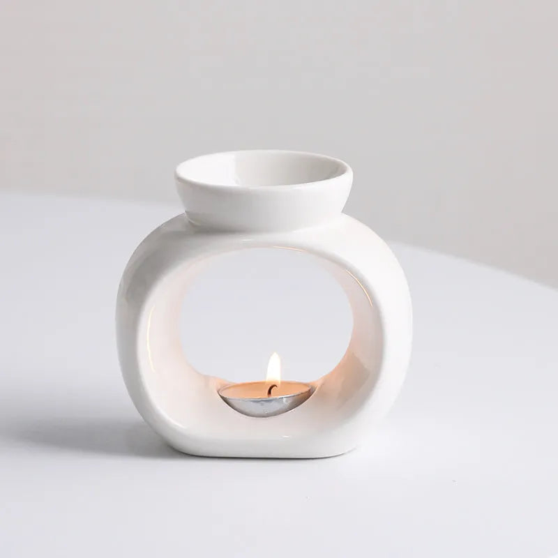 White Nordic minimalist ceramic aromatherapy stove ornament for indoor fragrance diffusion.