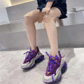 Women's leather sports shoes with a thick jelly sole and white cross-tie fastening on a round toe.