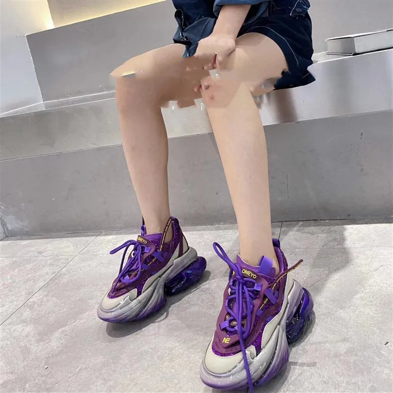 Women's leather sports shoes with a thick jelly sole and white cross-tie fastening on a round toe.