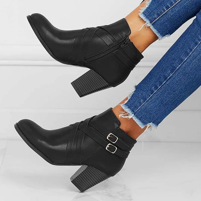 Women's grey PU leather ankle boot with a 7cm heel, side zipper, and belt buckle.