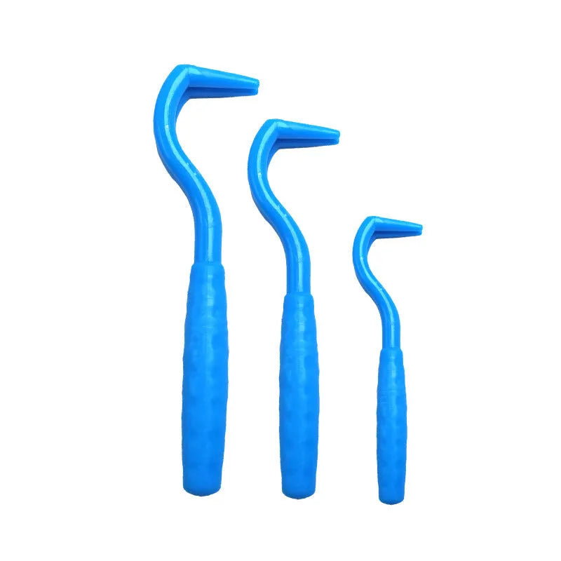 Three plastic tick removal hooks for dogs, shown in assorted colours on a white background.