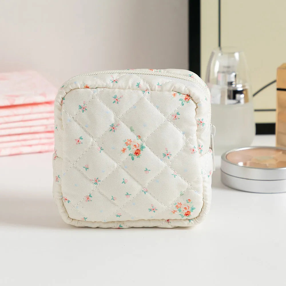 Women's floral patterned polyester key storage bag with sewing thread detail.