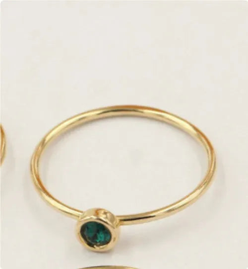 14K gold plated zircon knuckle ring on finger showing copper base with decorative stones