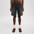 Men's loose straight leg jeans in light blue denim on a plain background