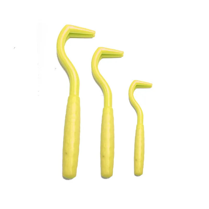 Three plastic tick removal hooks for dogs, shown in assorted colours on a white background.