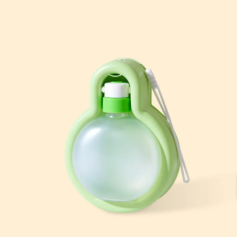 Green portable dog travel cup with integrated drinking bowl, showing 500ml capacity and pull-out bowl design.