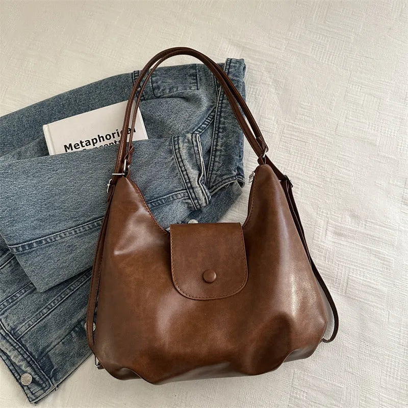 Women's PU leather shoulder bag in horizontal square shape with single strap, showing interior mobile phone compartment