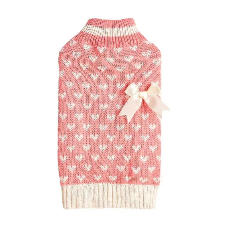 Red love heart design dog sweater on a small dog, showing acrylic knit fabric and playful motif.