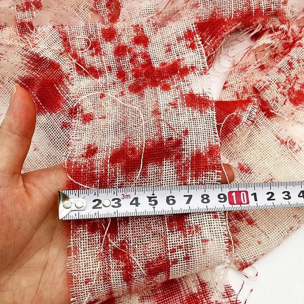 Roll of red Halloween horror gauze bandage with bloody dye effect, 8cm wide.